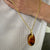 Oval Amber pendant in 18K gold.