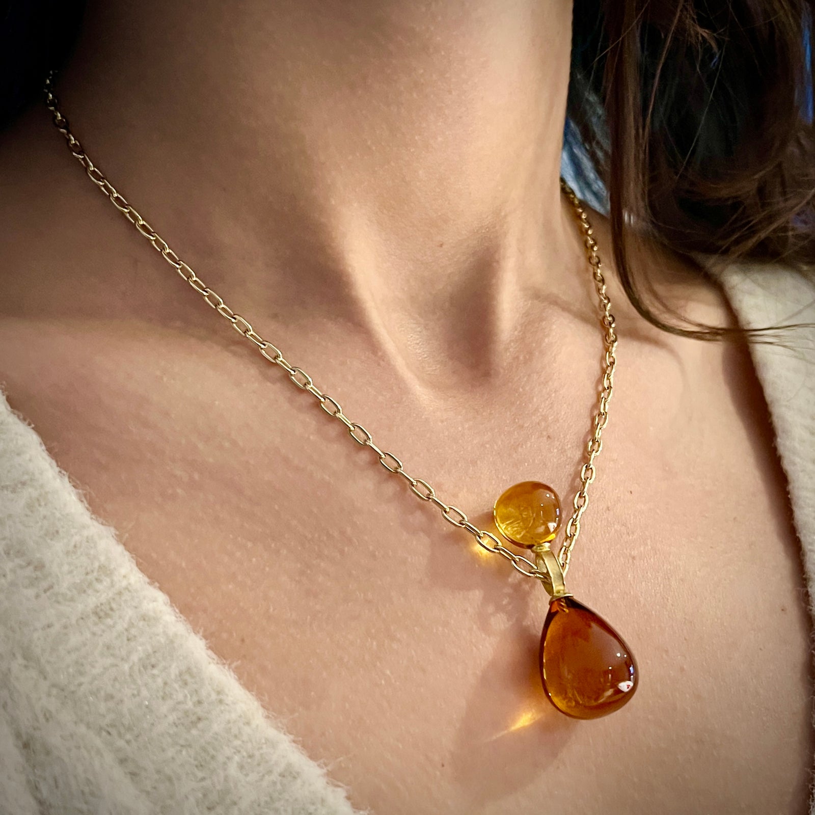 Stacked Baltic Amber pendant with 18K yellow gold 14k yellow gold chain shown on model made by Ayesha Mayadas
