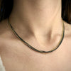 4 strand two-tone necklace in oxidized sterling silver and 14K yellow gold with lobster clasp shown on model by Ayesha Mayadas