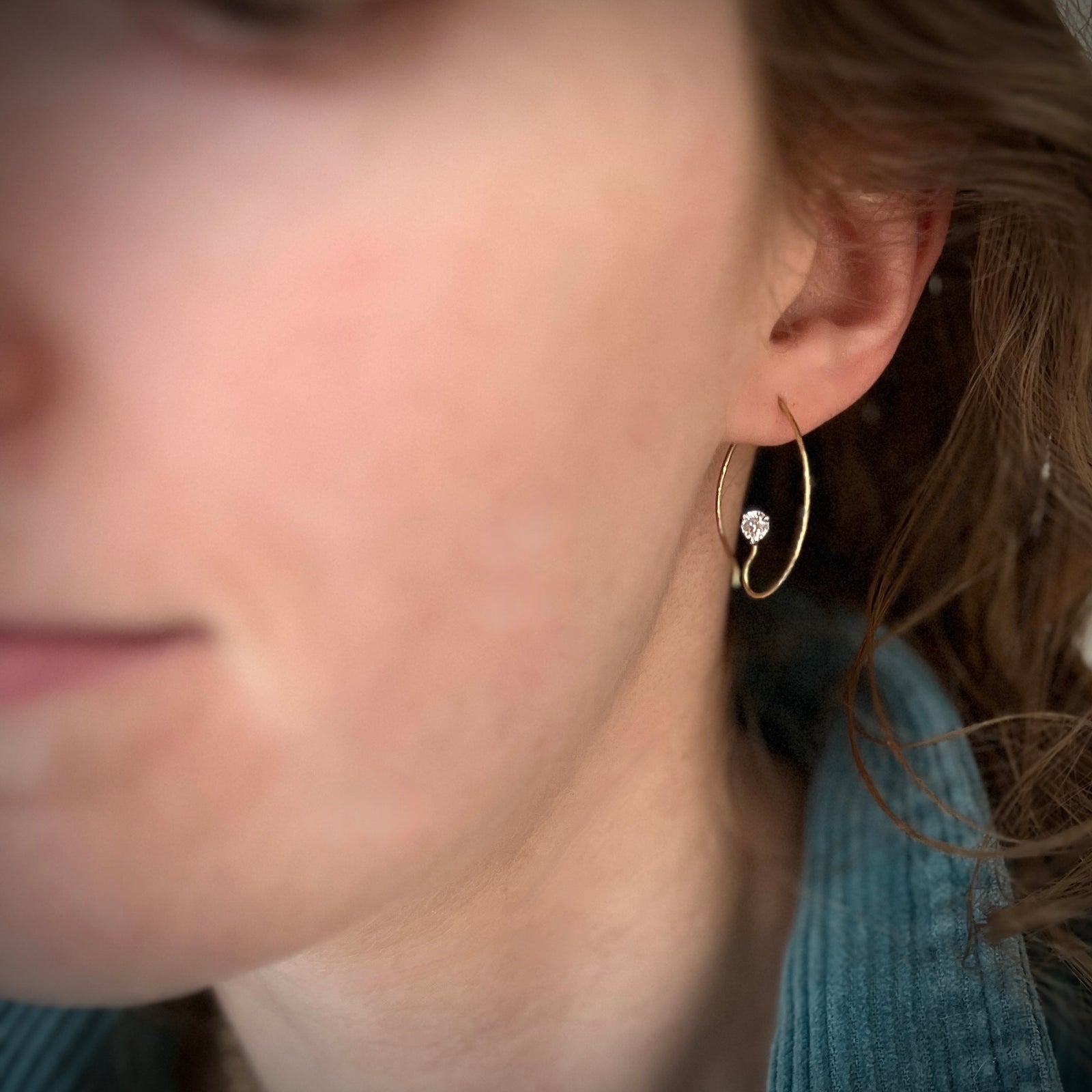A sweet,hammered hoop with a sparkle. The setting is nearly invisible. 18K gold, 2 diamonds (0.50 ct tw, lab created G/H, VS) are prong set in platinum.  Model is wearing an 18K yellow gold version