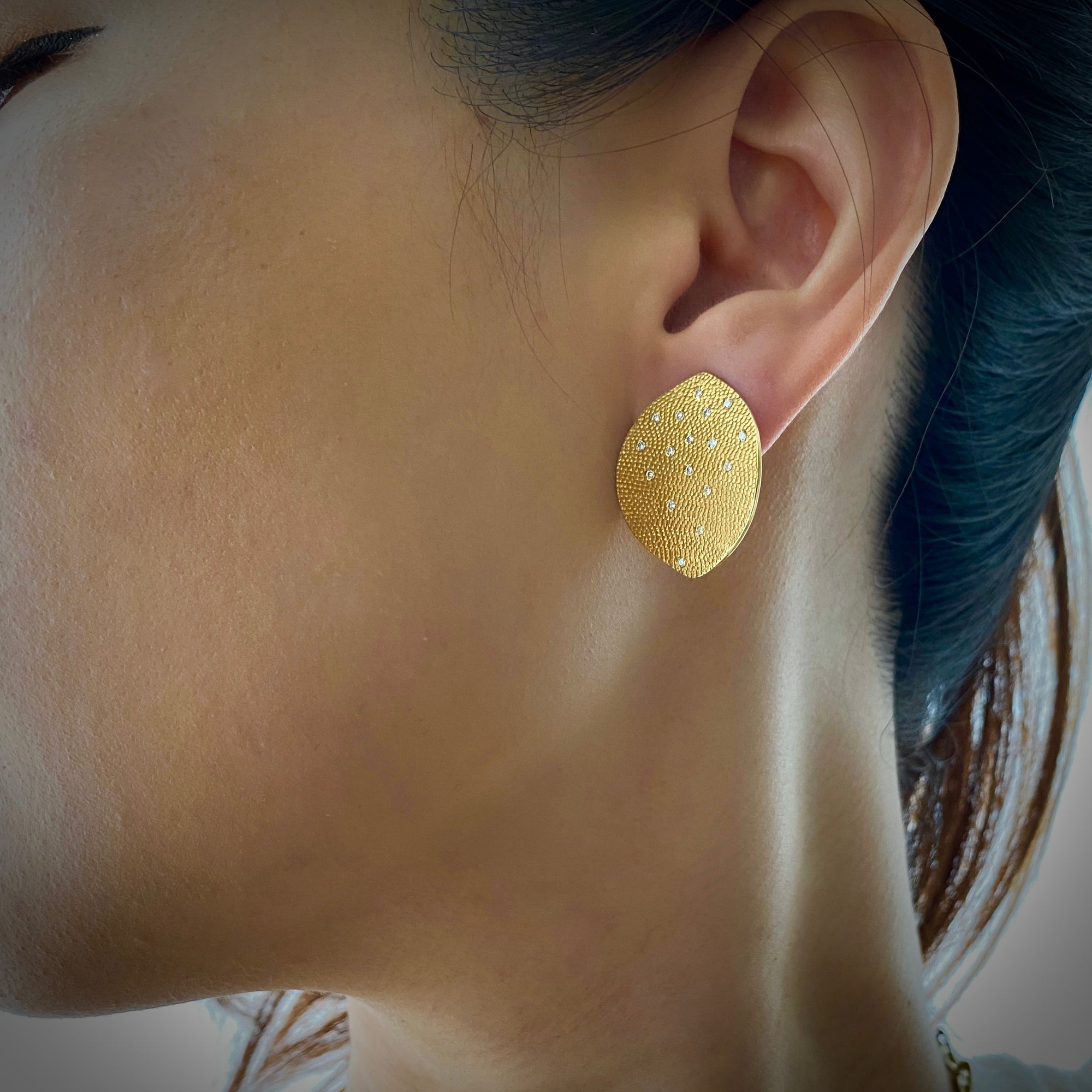 Textured leaf earrings in 18K yellow gold with diamonds by Ayesha Mayadas