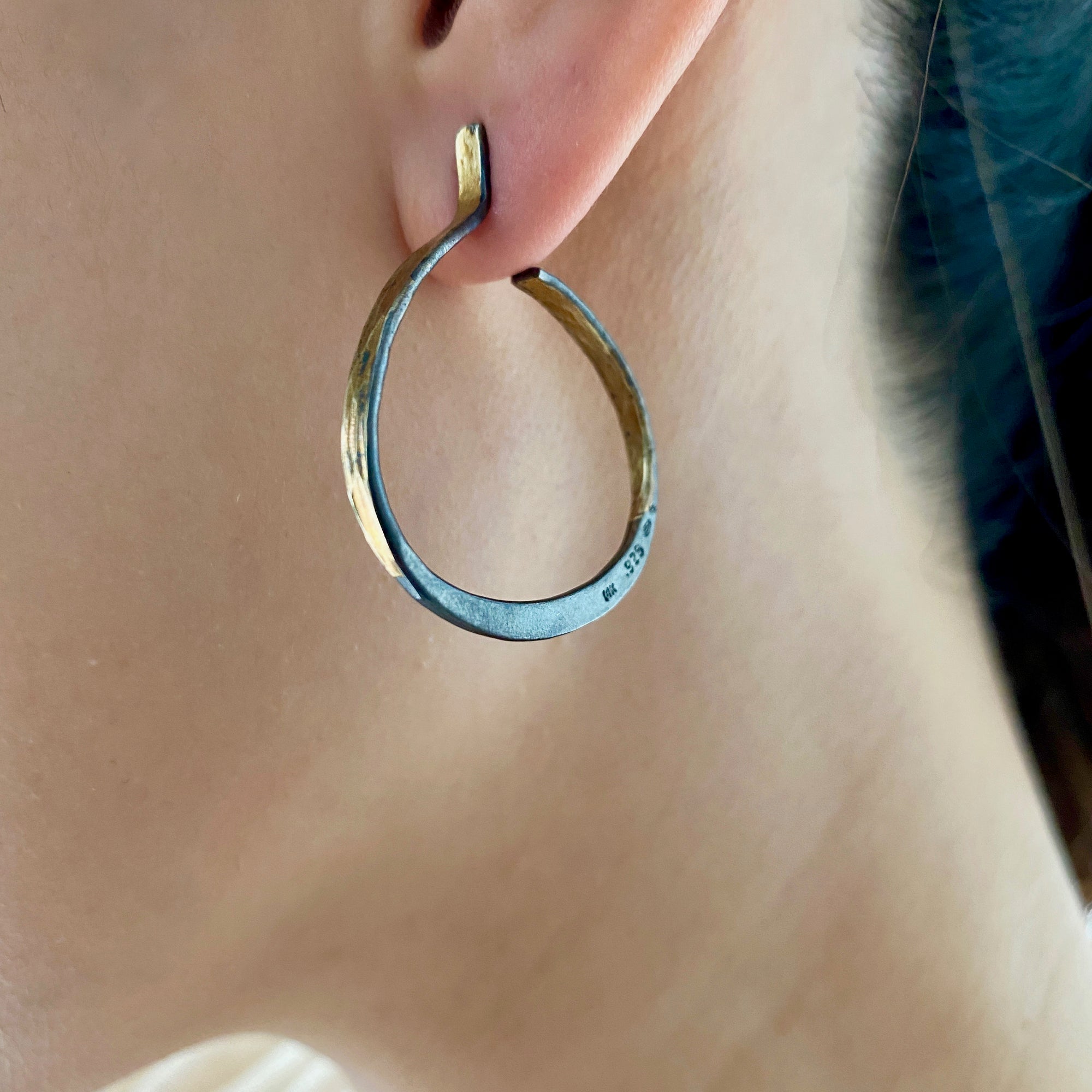 Splash Hoop off round Earrings in hammered 14K yellow Gold and sterling Silver shown on model post in 14K yellow gold by Ayesha Mayadas