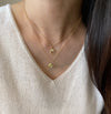 Delicate tear drop pendant in gold with round diamonds worn with spiral pendant with dangling diamond by Ayesha Mayadas