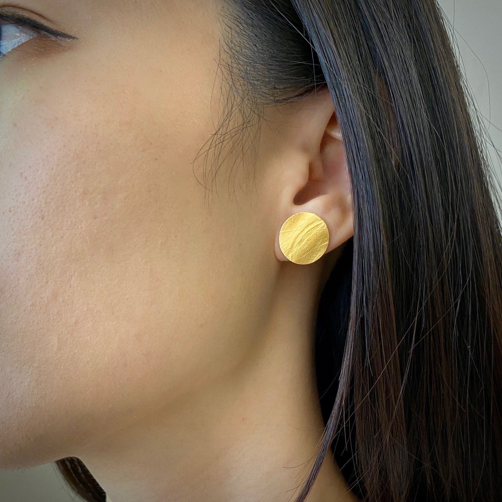 Round wafer stud earrings in sterling silver with an 18K yellow gold Vermeil finish by Ayesha Mayadas