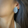 Leaf motif earrings in oxidized sterling silver and a stripe of 14K yellow gold shown on model by Ayesha Mayadas