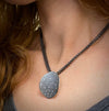 Leaf pendant in oxidized sterling with diamonds on double chain shown on model made by Ayesha Mayadas