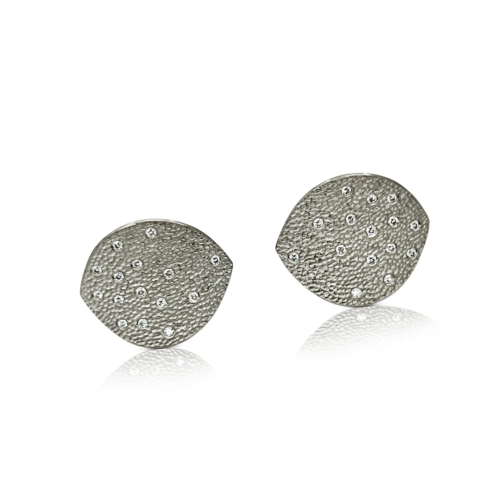 Leaf shaped earrings with diamonds in platinum by Ayesha Mayadas