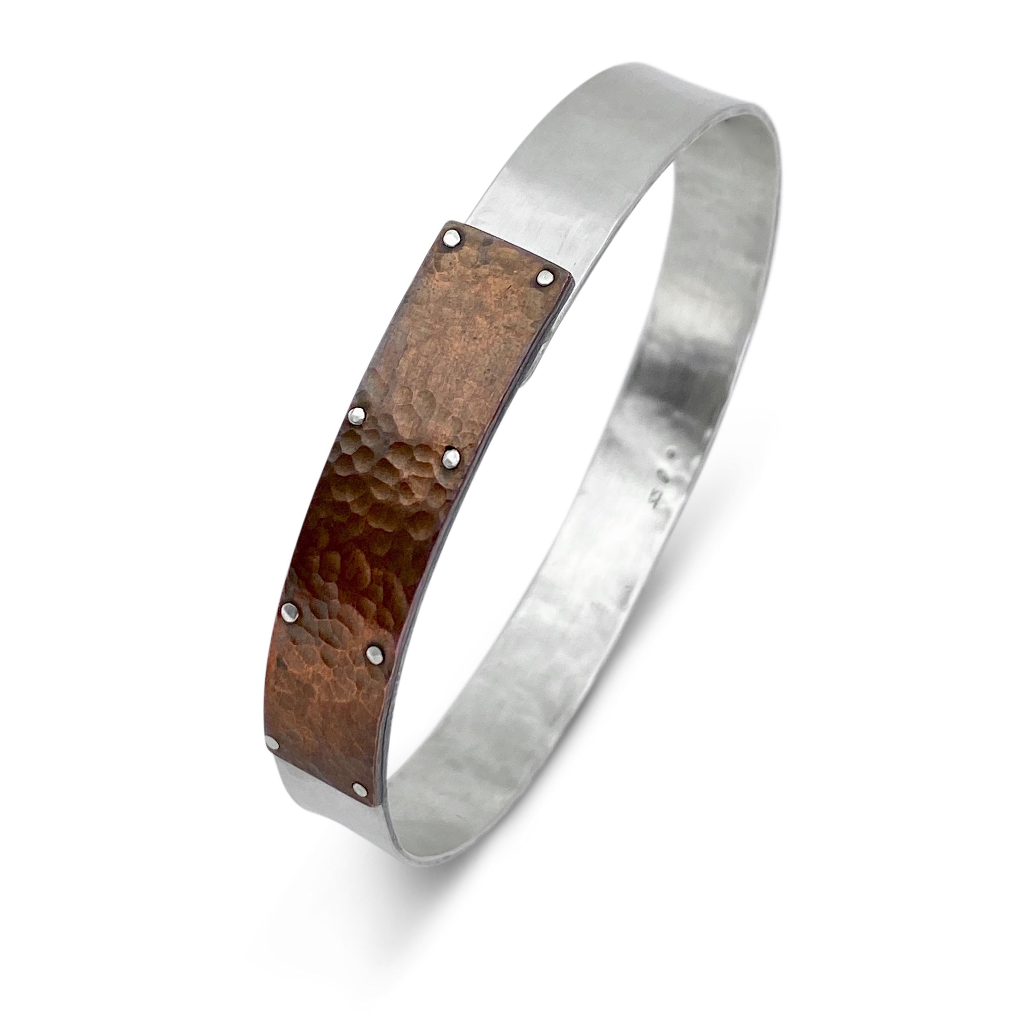 Rugged men's cuff in sterling silver and hammered copper by Ayesha Mayadas