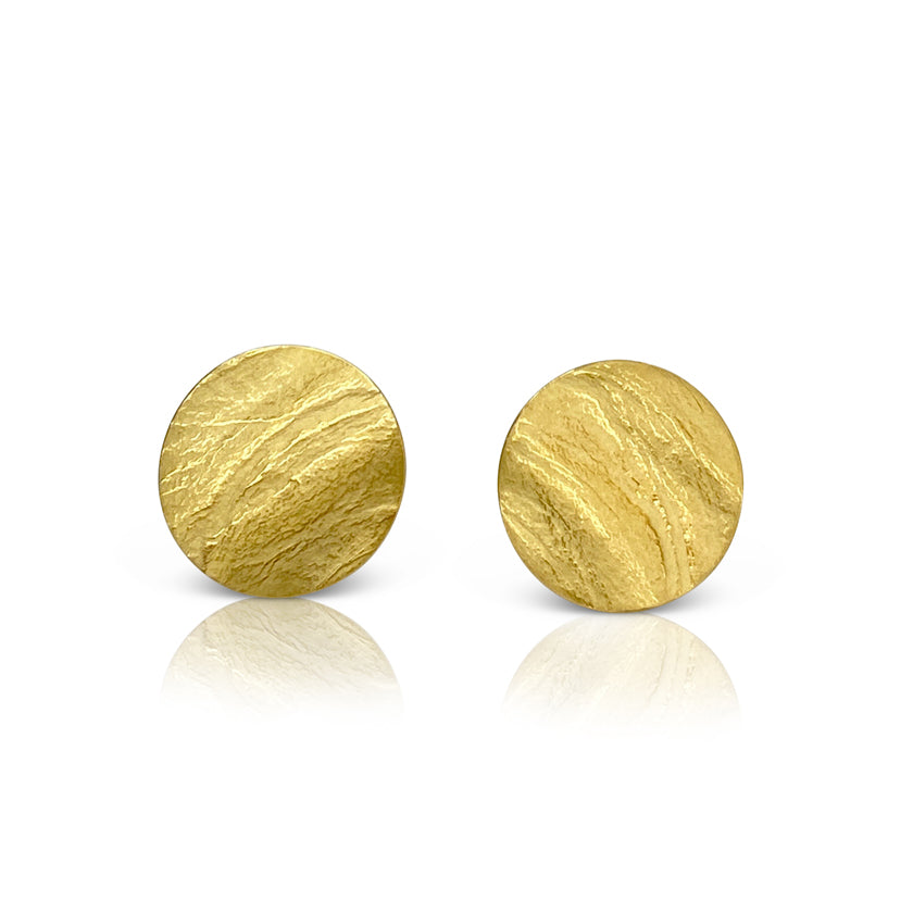 Round wafer stud earrings in sterling silver with an 18K yellow gold Vermeil finish by Ayesha Mayadas