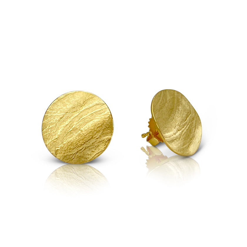 Round wafer stud earrings in sterling silver with an 18K yellow gold Vermeil finish by Ayesha Mayadas