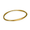 Forged sterling silver and vermeil bangle by Ayesha Mayadas