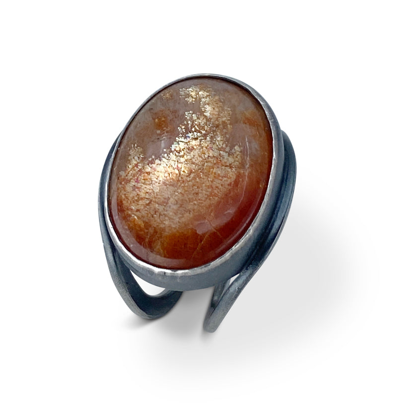 Oval shaped Sunstone ring with 2 orange sapphires set at the bottom of the shank in sterling silver by Ayesha Mayadas