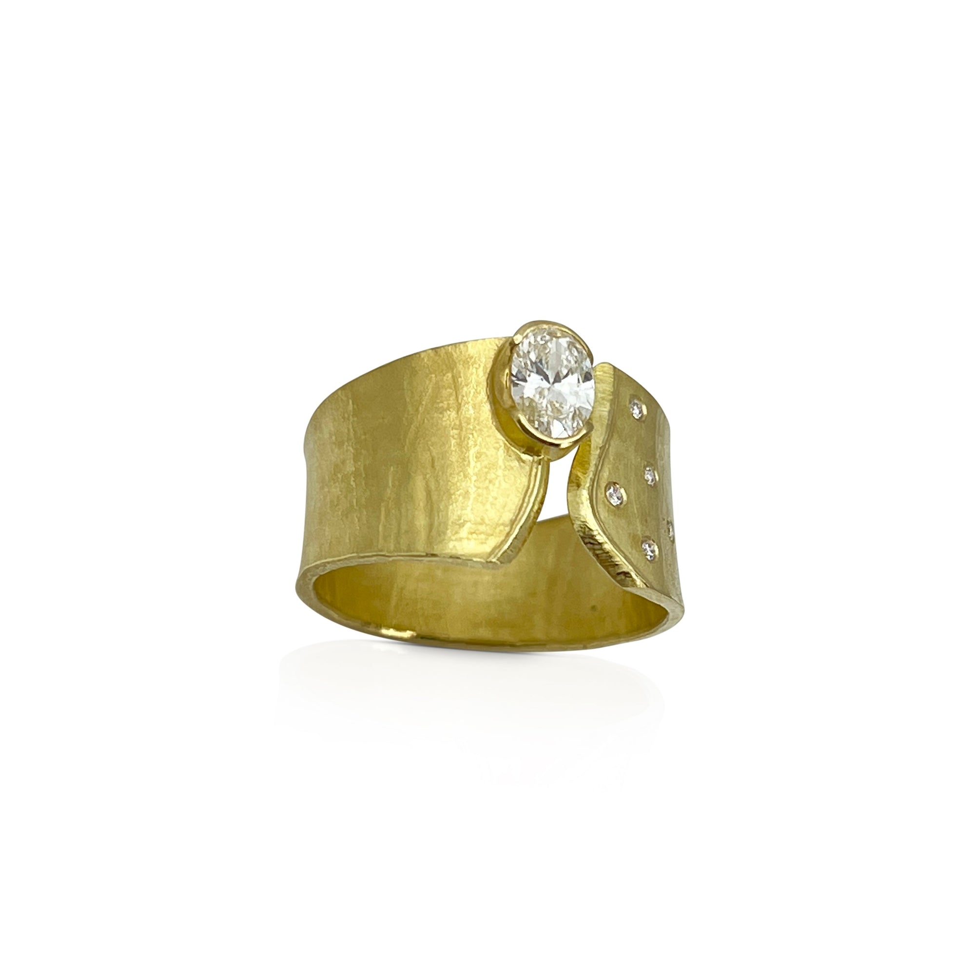 Wide Wafer ring in 18K yellow gold with oval lab diamond and 5 small offset side diamonds by Ayesha Mayadas