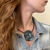 Bronze plate with patina, black leather cord 16&quot;.  Can also be worn as a brooch, made by Marcin Zaremski