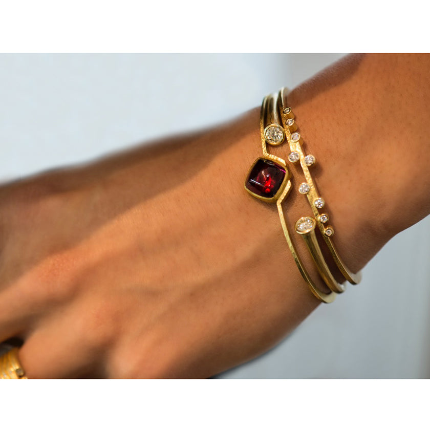 Model is wearing Stepped cuff with diamonds, whisper cuff with diamonds and V cuff with rubellite in 18K yellow gold by Ayesha Mayadas