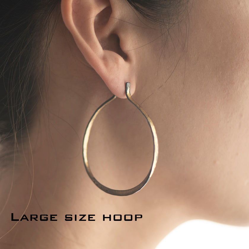 large size Splash Hoop off round Earrings in  14K yellow hammered Gold overlay on Silver shown on model by Ayesha Mayadas